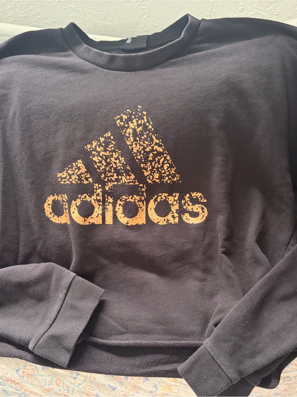 adidas Womens Cropped Black Crewneck Sweatshirt with Distressed Gold Logo